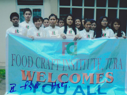 Holding a banner of food craft institute, Tura